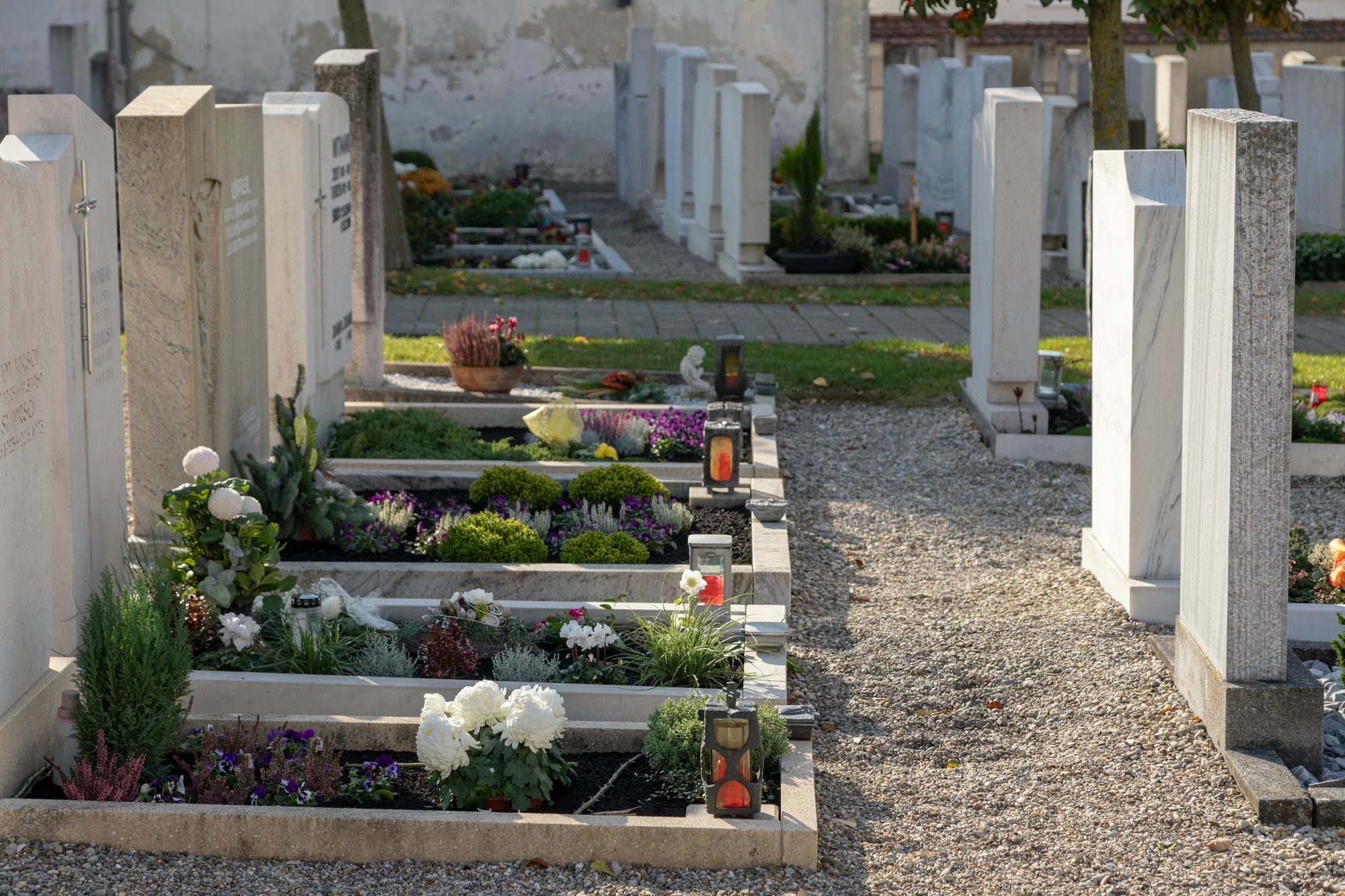 Graves in a cemetery on All Saints’ Day Photo by Norbert Staudt on Unsplash